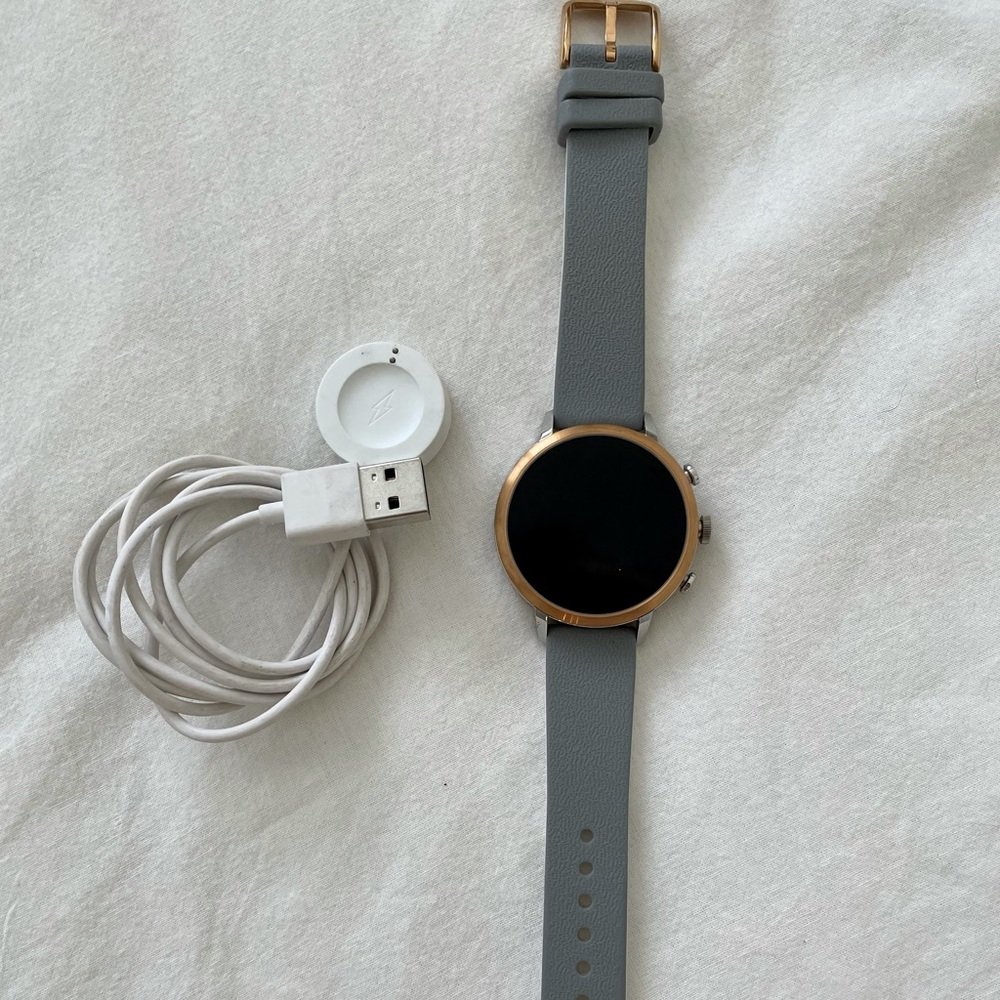 Fossil (gen 2?) smart watch with gray wristband and charger